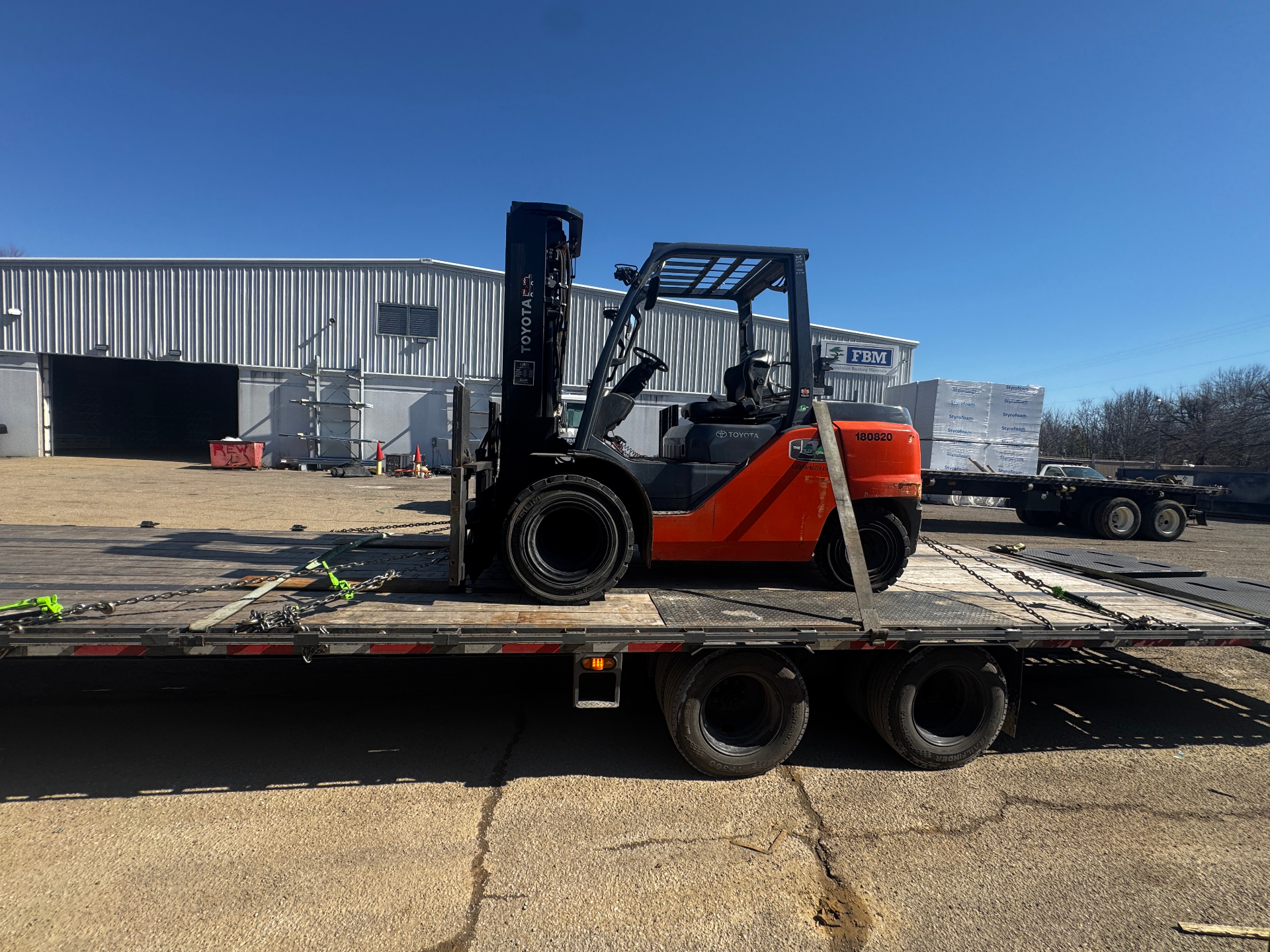 Military equipment loaded and secured on flatbed trailer