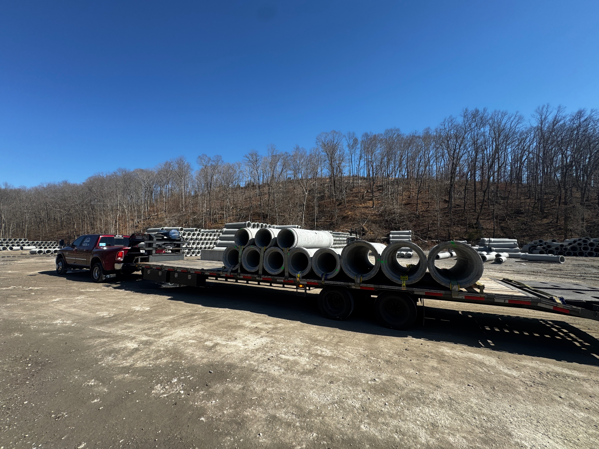 Construction equipment transport on open road, rural landscape