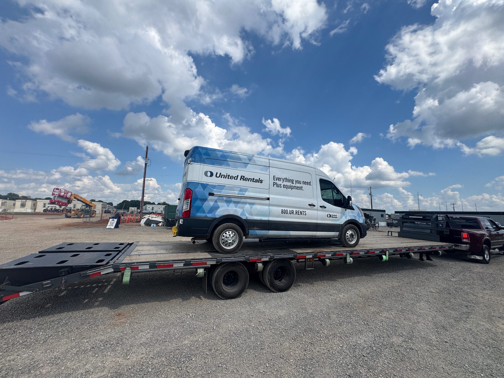 Industrial machinery being loaded onto flatbed with winch system